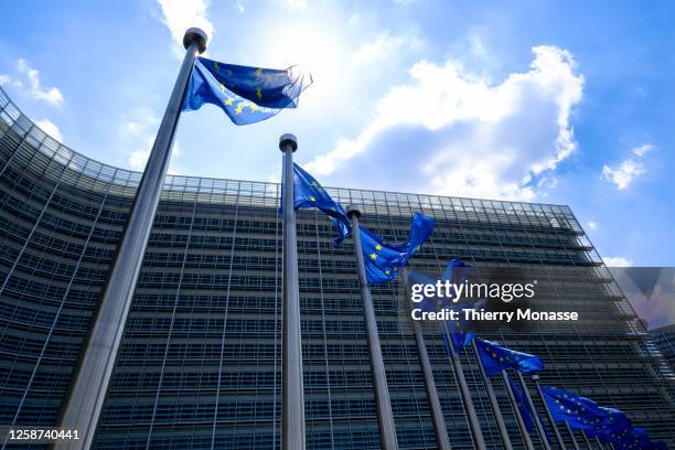 The EU flags flutter in the wind in front of the Berlaymont, the EU Commission headquarter on June 16, 2023 in Brussels, Belgium. The Flag of Europe,...