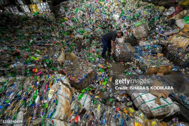 Worker sorts plastic bottles at Sri Lanka's largest plastic recycling facility Eco Spindles, in Horana on June 16, 2023. Eco Spindles Private Limited...