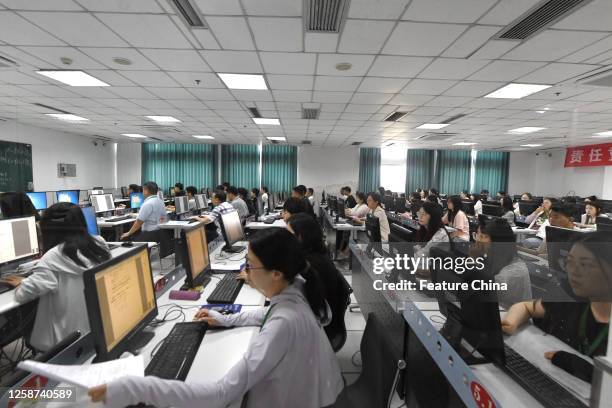 Referees judge the scanned test papers of a Gaokao exam in Nanjing in east China's Jiangsu province.