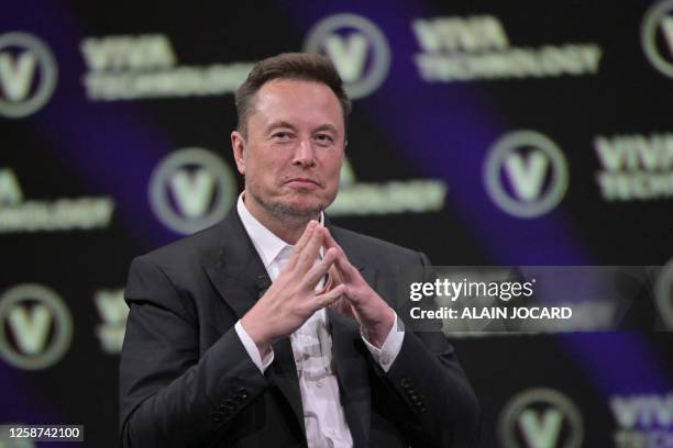 SpaceX, Twitter and electric car maker Tesla CEO Elon Musk reacts as he speaks during his visit at the Vivatech technology startups and innovation...