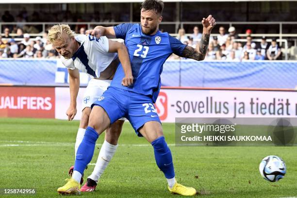 Slovenia's defender David Brekalo and Finland's forward Joel Pohjanpalo vie for the ball during the UEFA Euro 2024 group H qualification football...
