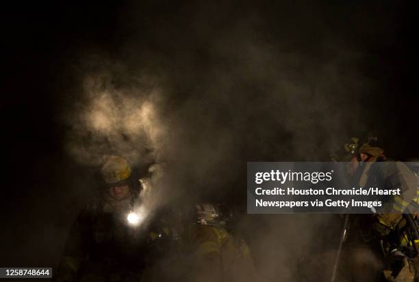 Firefighters battle a fire at the Iglesia Cristiana Monte Sinai in the Solon Business park on Solon Road in Northwest Harris County early Friday...