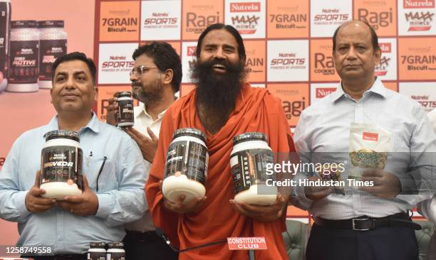 Yoga Guru Baba Ramdev and Patanjali Foods CEO Sanjeev Asthana and others during the launch of Patanjali premium products at Constitution Club of...