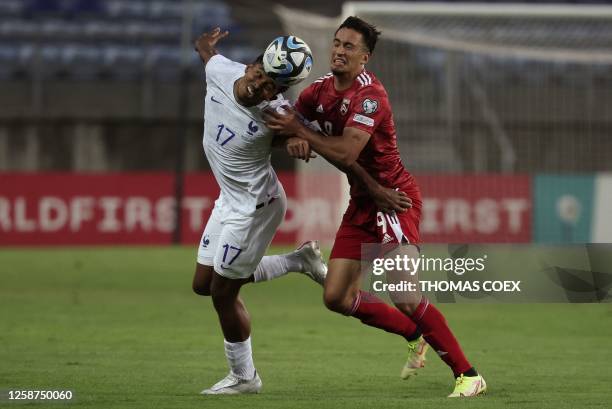 France's defender Wesley Fofana fights for the ball with Gibraltar's midfielder Ayoub El Hmidi during the UEFA Euro 2024 group B qualification...