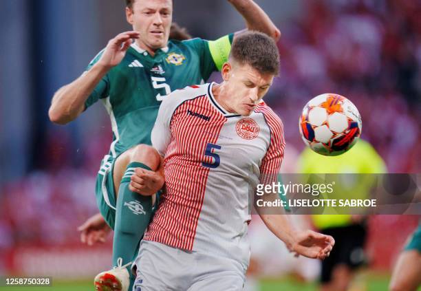 Northern Ireland's defender Jonny Evans and Denmark's defender Joakim Maehle vie for the ball during the UEFA Euro 2024 group H qualification...