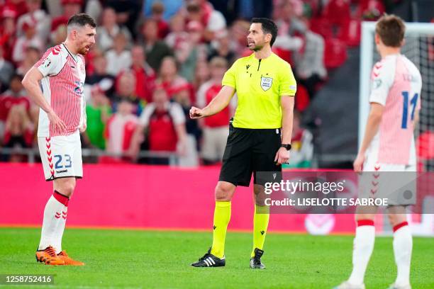 Polish Referee Daniel Stefanski awaits a pending VAR decision during the UEFA Euro 2024 group H qualification football match between Denmark and...