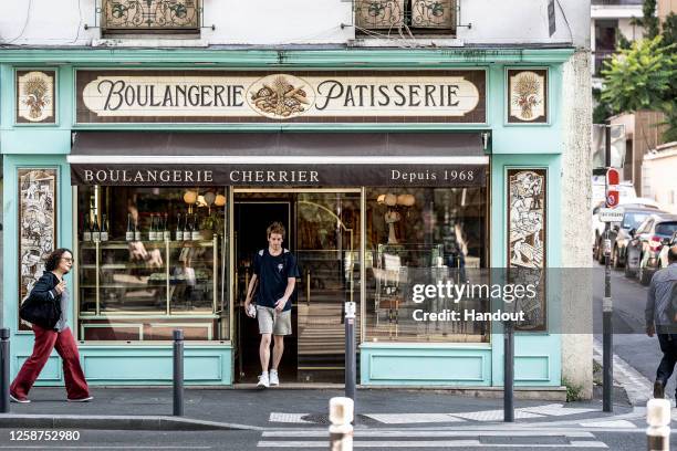 In this handout image provided by Red Bull, Gary Hunt of France exits a bakery while on his way through the streets of Paris to the training day of...