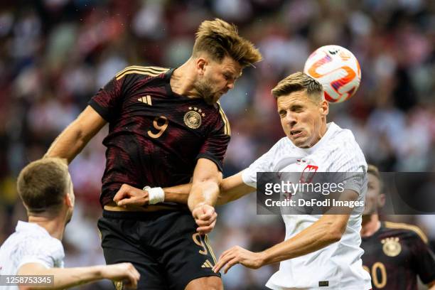 Niclas Fullkrug of Germany and Jan Bednarek of Poland battle for the ball during the international friendly match between Poland and Germany at...