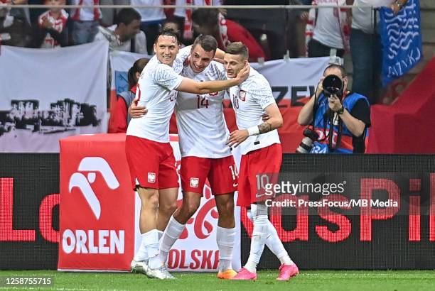 Jakub Kiwior, Piotr Zielinski and Sebastian Szymanski of Poland celebrate scoring the goal with team mates during the international friendly match...