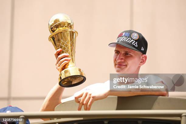 Nikola Jokic of the Denver Nuggets celebrates with the Bill Russell Finals MVP Trophy during the 2023 Denver Nuggets Championship Parade on June 15,...