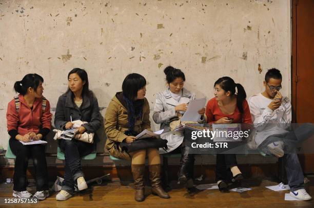 Unemployed people seek various jobs at an employment fair held at a stadium in Hefei, east China's Anhui province on November 11, 2009. CChina's...