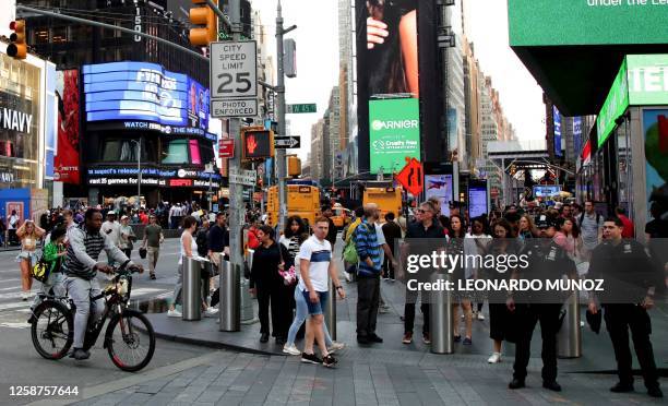 People walk through Times Square in New York City on June 16, 2023.