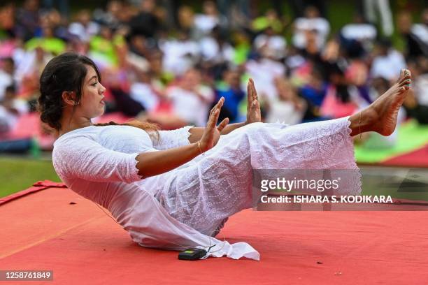 Yoga instructor leads a mass yoga session organized by the Indian High Commission Office at Independence square in Colombo on June 17 ahead of...