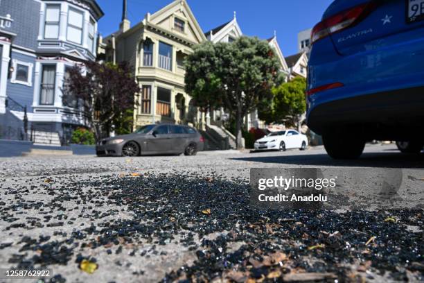 Broken car window glass pieces are seen by a curb in Alamo Square of San Francisco, California, United States on June 16, 2023. Car break-ins have...