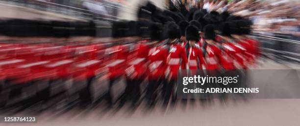 Members of different Households Divisions Foot Guards, leave Buckingham Palace to parade down The Mall during the King's Birthday Parade, 'Trooping...