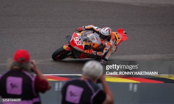 Honda Spanish rider Marc Marquez steers his motorbike during the qualifying session for the MotoGP German motorcycle Grand Prix at the Sachsenring...