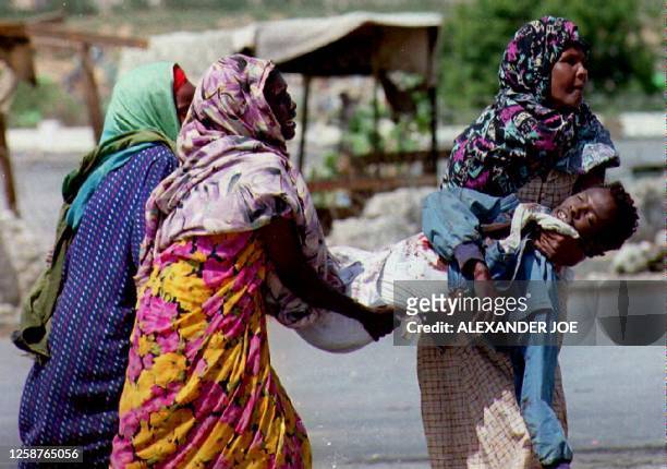 Women cry as they carry one of the 14 civilians killed by Pakistani United Nations peacekeeping troops 13 June 1993 in Somalia. The troops opened...