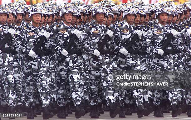 Chinese special forces in winter camouflage goose-step with their bayonettes as they pass Chinese President Jiang Zemin on Tiananmen Square's rostrum...