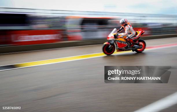 Repsol Honda Team's Spanish rider Marc Marquez leaves the pits for the qualifying session for the MotoGP German motorcycle Grand Prix at the...