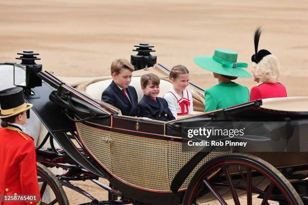 Prince George of Wales, Princess Charlotte of Wales and Prince Louis of Wales ride in a horse drawn carriage with Catherine, Princess of Wales and...
