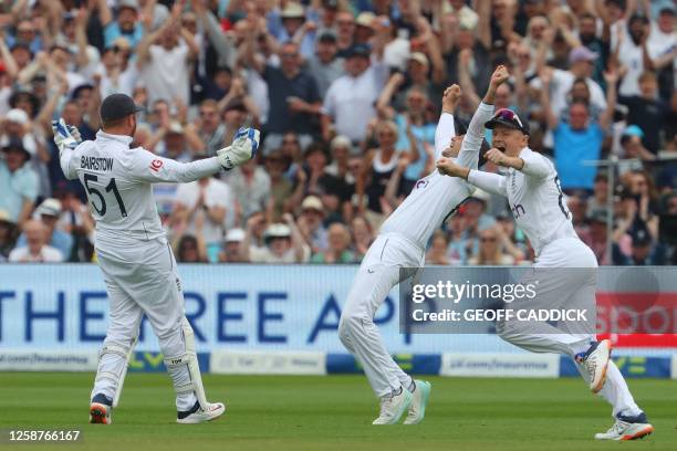 England's Jonny Bairstow celebrates with England's Joe Root and England's Ollie Pope after taking a catch to dismiss Australia's Marnus Labuschagne...