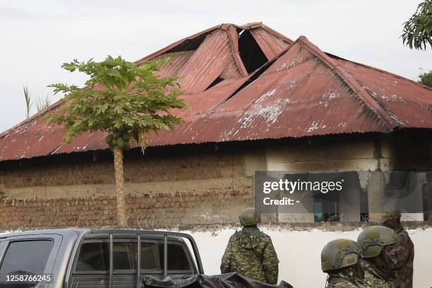 Uganda security forces are seen standing at the premises of an attack in Mpondwe, Uganda, on June 17, 2023 at the Mpondwe Lhubiriha Secondary School....