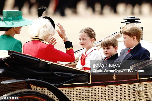 Queen Camilla, Prince George , Prince Louis, the Princess of Wales and Princess Charlotte ride in a carriage as they take part in the Royal...