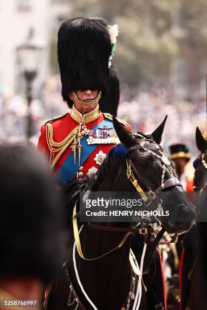 Britain's King Charles III rides back to Buckingham Palace after the King's Birthday Parade, 'Trooping the Colour', in London on June 17, 2023. The...
