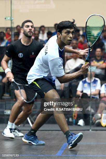 Malaysia's Darren Pragasam plays against Egypt's Aly Abou EI Einen during the Finals match of SDAT WSF Squash World Cup held in Chennai on June 17,...