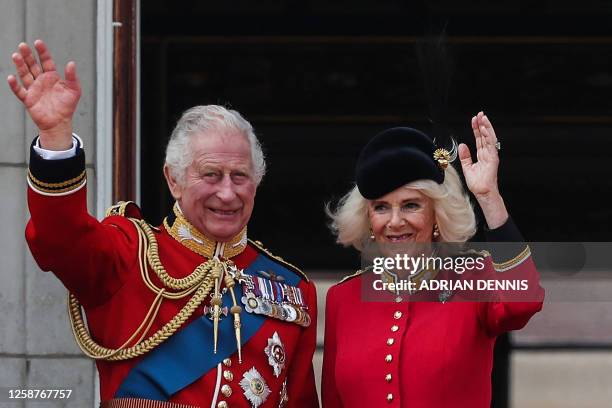 Britain's King Charles III and Britain's Queen Camilla wave from the balcony of Buckingham Palace after attending the King's Birthday Parade,...