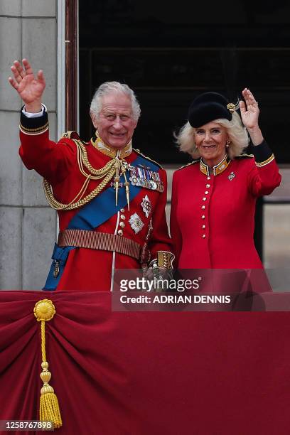 Britain's King Charles III and Britain's Queen Camilla wave from the balcony of Buckingham Palace after attending the King's Birthday Parade,...