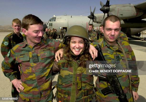 Belgian singer Melanie poses with Belgian soldiers at the end of the visit of Belgian Defence Minister Andre Flahaut to the Belgian soldiers of the...