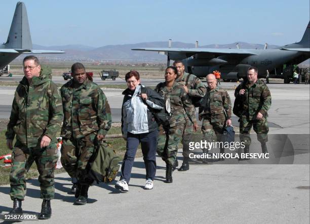 Group of US soldiers walk on the tarmac upn their arrival at Pristina, airport, Kosovo, 20 March 2004 after they flew from the US military base in...