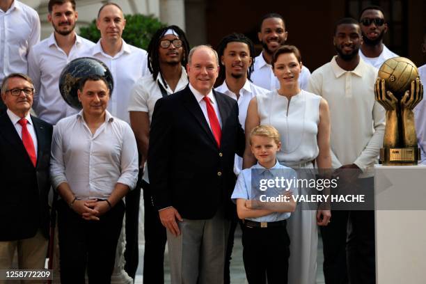 Prince Albert II of Monaco , Prince Jacques of Monaco and Princess Charlene of Monaco pose with the AS Monaco Basket team players and leading staff...