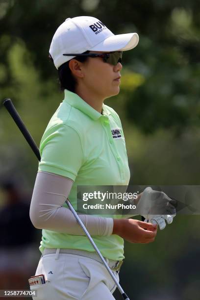 Jeongeun Lee5 of Seoul, Republic of Korea removes her glove after hitting from the fairway to the first green during the third round of the Meijer...