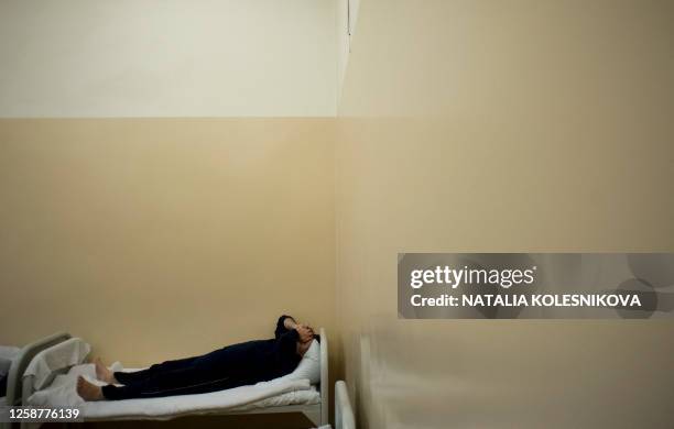 Patient lays in a bed in a ward of the Serbsky State Scientific Center for Social and Forensic Psychiatry in Moscow on October 10, 2011. The Serbsky...