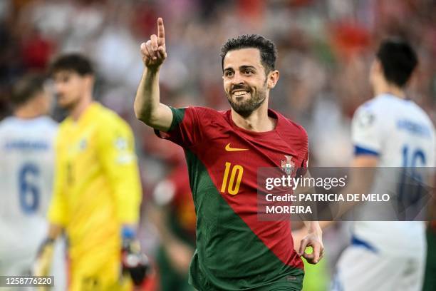 Portugal's midfielder Bernardo Silva celebrates after scoring his team's first goal during the UEFA Euro 2024 group J qualification football match...