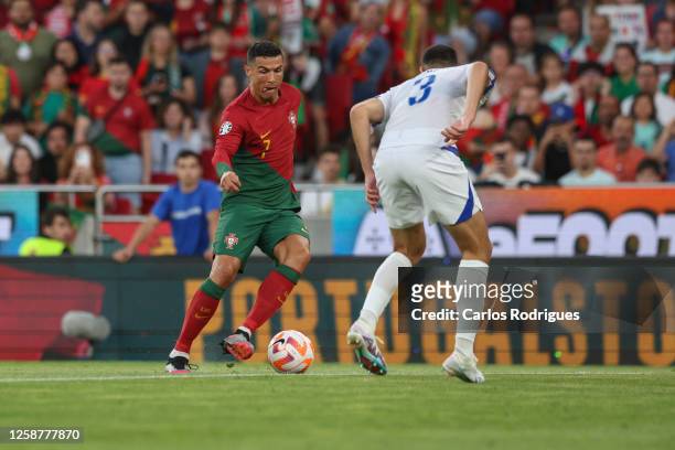 Cristiano Ronaldo of Portugal tries to pass trough Adrian Leon Barisic of Bosnia Herzegovina during the UEFA EURO 2024 qualifying round group J match...
