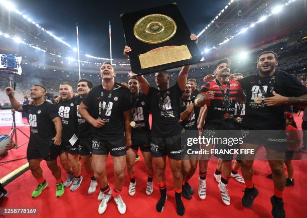 Toulouse players celebrate with the Bouclier de Brennus trophy after winning the French Top14 rugby union final match between Stade Toulousain Rugby...