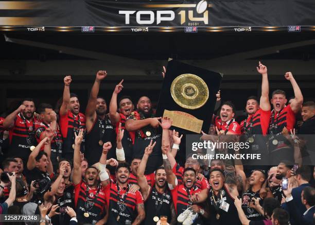 Toulouse's New Zealand prop Charlie Faumuina and Toulouse's French scrum-half Antoine Dupont celebrate holding the Bouclier de Brennus trophy after...