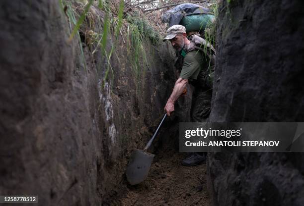 Ukrainian soldier digs a trench at the front line near the town of Kreminna, Lugansk region, on June 17 amid the Russian invasion of Ukraine.