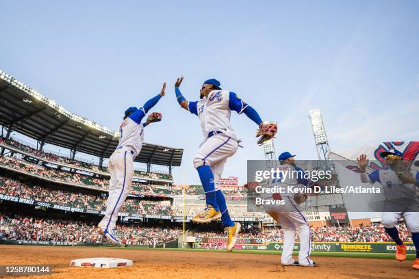 Ronald Acuna Jr. #13 of the Atlanta Braves high fives Ozzie Albies after the win over the Colorado Rockies at Truist Park on June 17, 2023 in...