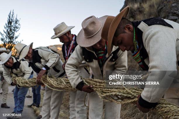 People from different communities participate in the annual renovation of the Q'eswachaka rope bridge near Huinchiri, Quehue District, Cusco...