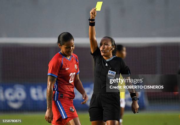 Guatemalan referee Astrid Gramajo shows a yellow card to Panama's Monica Ramos during the friendly football match between Panama and Colombia, ahead...