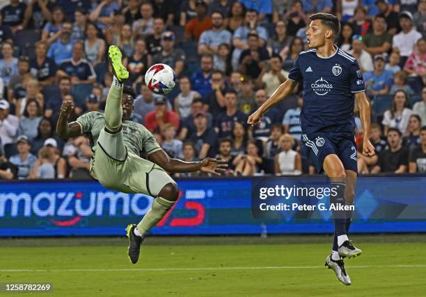 Jesus Murillo of Los Angeles FC clears the ball against Daniel Salloi of Sporting Kansas City in the second half on June 17, 2023 at Children's Mercy...