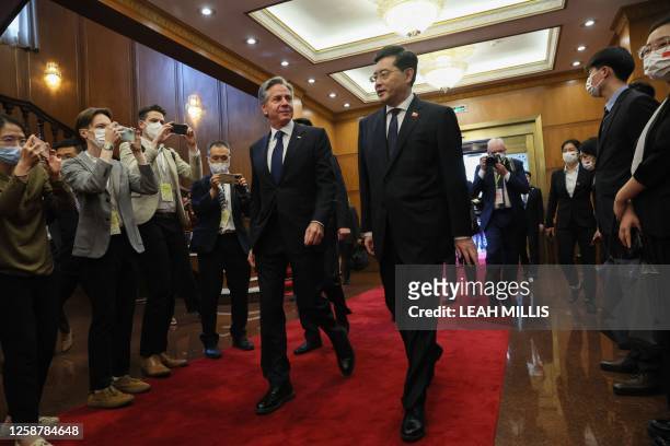 Secretary of State Antony Blinken walks with China's Foreign Minister Qin Gang ahead of a meeting at the Diaoyutai State Guesthouse in Beijing on...
