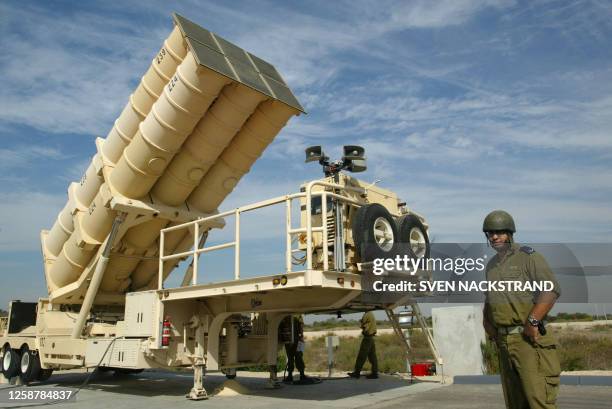 Israeli soldiers raise to it's upright position an Arrow missile launcher with it's six missiles, during a tour for foreign correspondents at the...