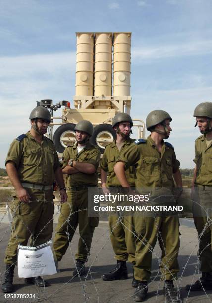 Israeli soldiers stand in front of an Arrow missile launcher with it's six missiles, during a tour for foreign correspondents at the Palmahim air...