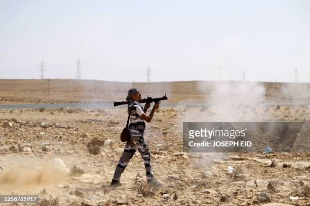 Libyan National Transitional Council fighter fires an RPG as he exercises at an outpost in the city of Bani Walid on September 20, 2011 where Libyan...