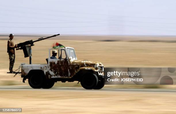 Libyan National Transitional Council fighters arrive at the frontline in city of Bani Walid on September 22, 2011 as forces loyal to Libya's new...